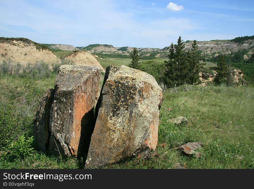 Unique split rock sitting in a badlands landscape