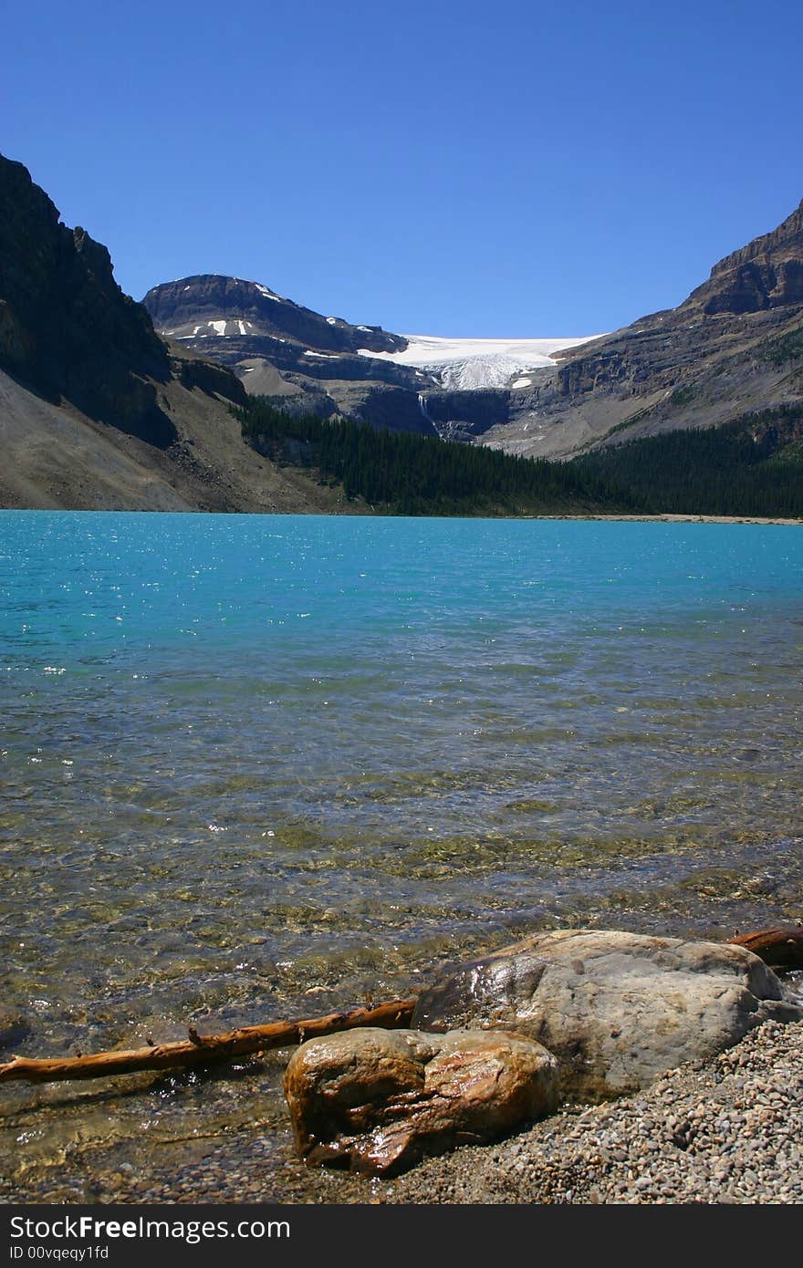 Several ols boulders laying near the shore of an amazing crystal blue lake in the Canadian Rockies. Several ols boulders laying near the shore of an amazing crystal blue lake in the Canadian Rockies