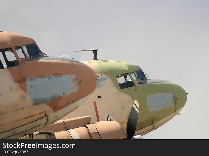 Detail of two old planes sitting in an airfield storage compound. Detail of two old planes sitting in an airfield storage compound