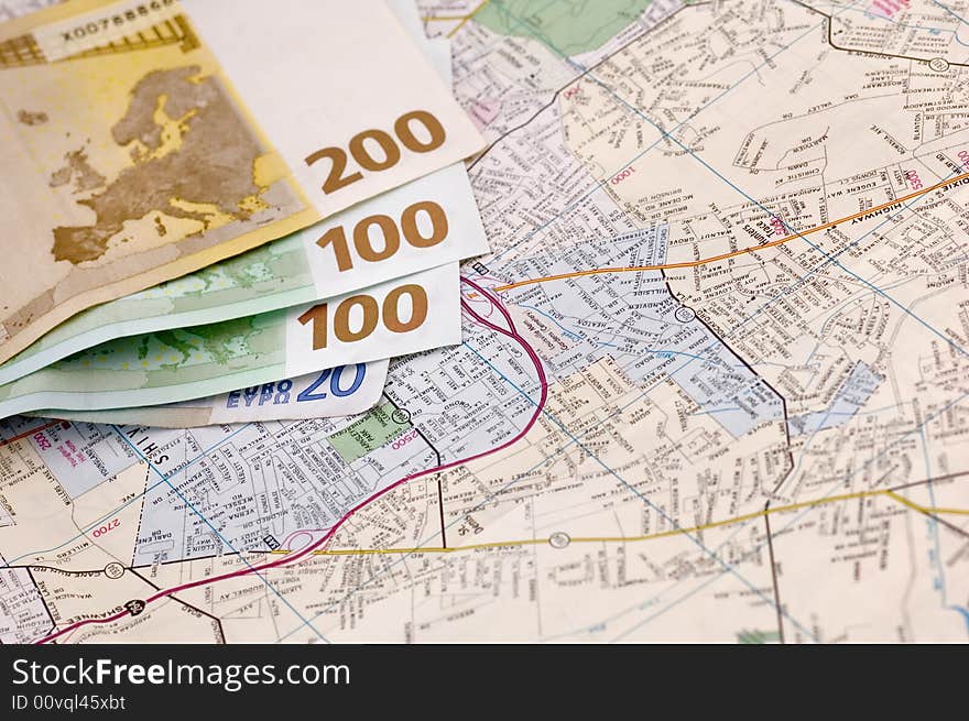 Banknotes of euros on the map