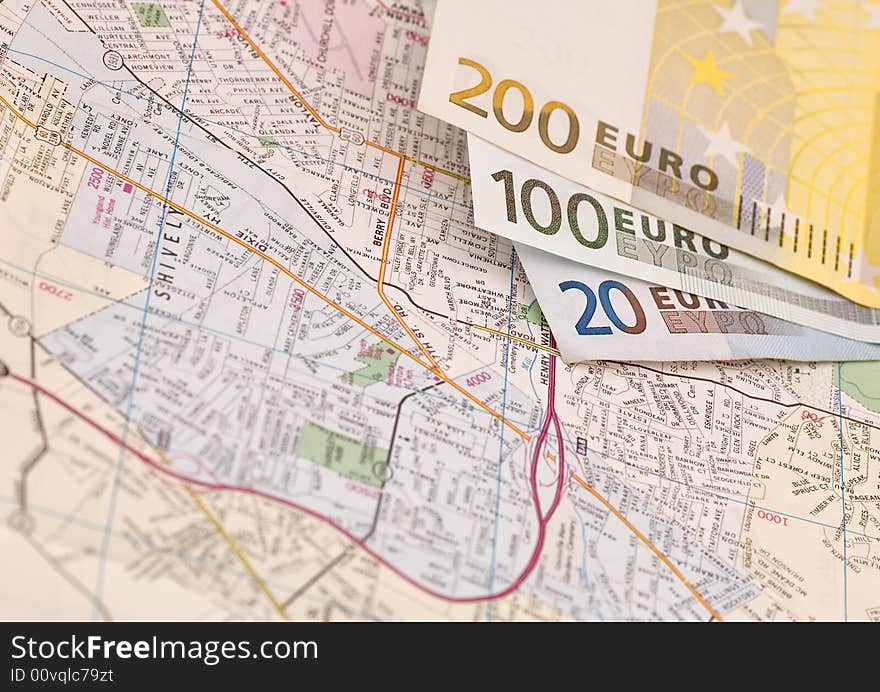 Banknotes of euros on the map