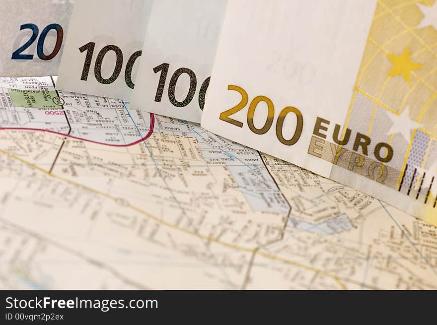 Banknotes of euros on the map