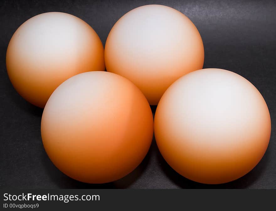 Abstract pattern of orange balls on black background