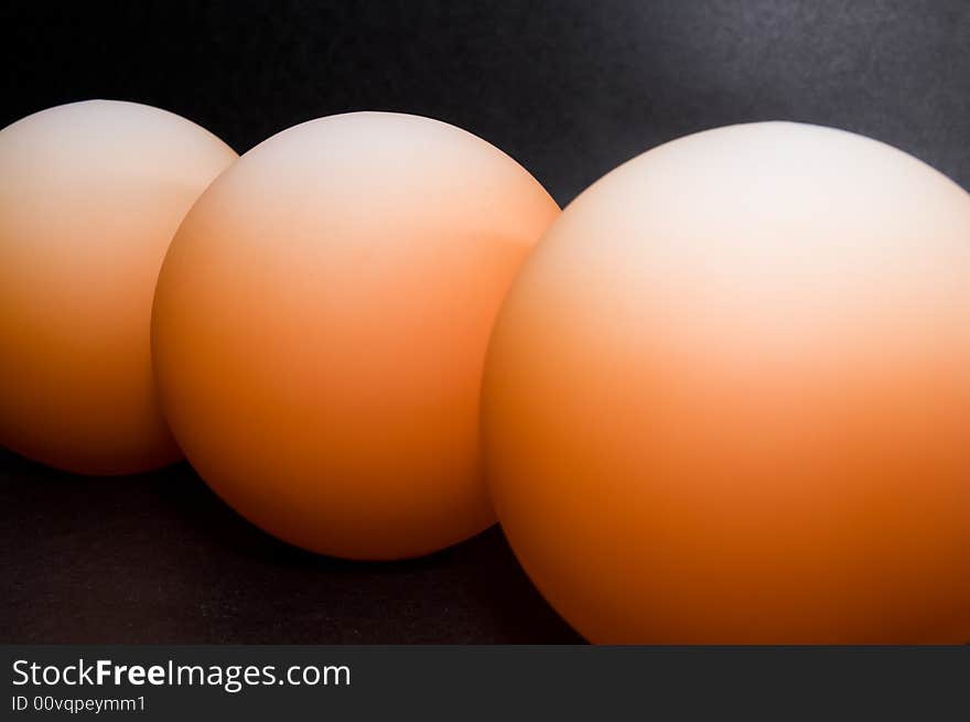 Abstract pattern of orange balls on black background