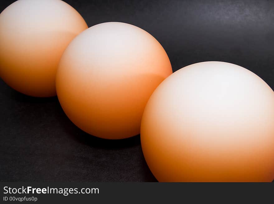 Abstract pattern of orange balls on black background