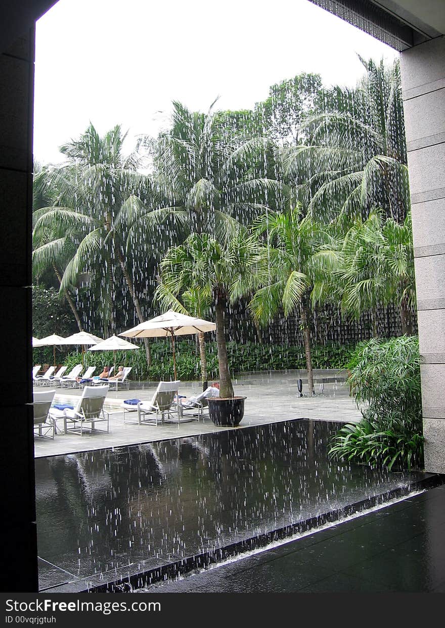 Beach view through artificial waterfall. Beach view through artificial waterfall