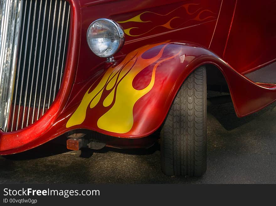 A classic bright red hotrod with flames. A classic bright red hotrod with flames