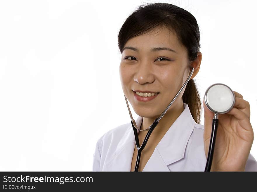 Female doctor holding a stethoscope in white background. Female doctor holding a stethoscope in white background.