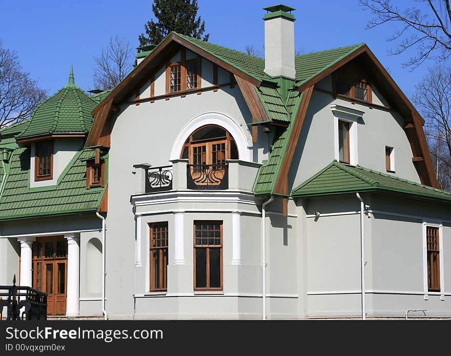 Cottage with a green roof. Saint-petersburg, Russia