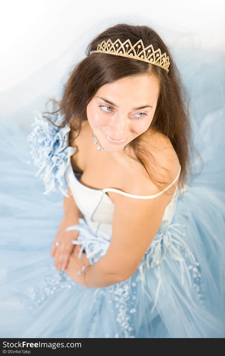 Beauty bride in blue dress sitting on floor