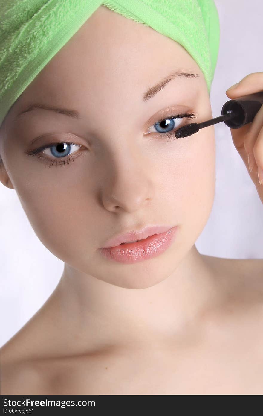 Girl in the towel doing make-up. Girl in the towel doing make-up