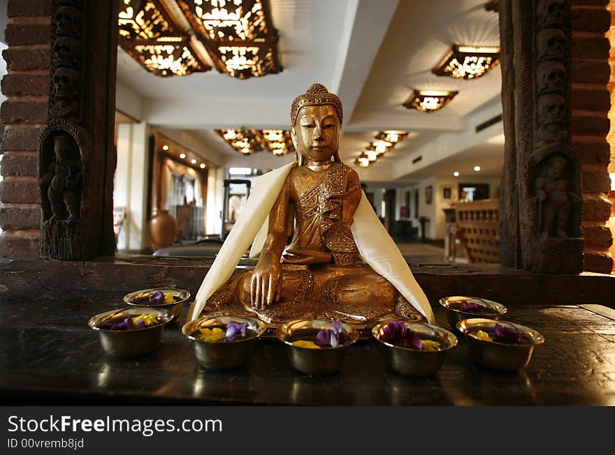 Buddha statue in front of mirror in hotel entrance