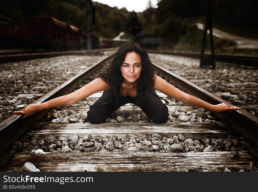 A girl kneeled on railway line. A girl kneeled on railway line