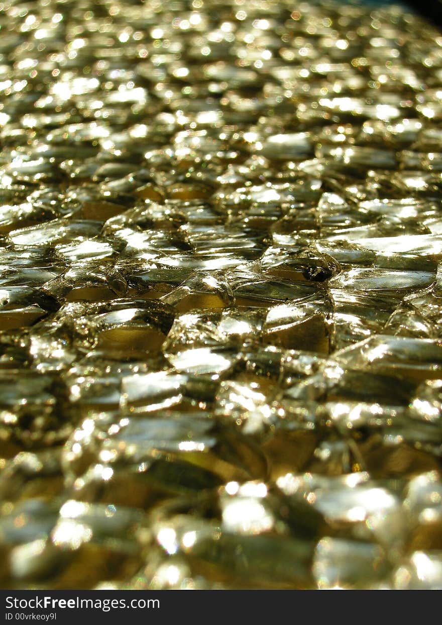 Shattered glass closeup with gold colour