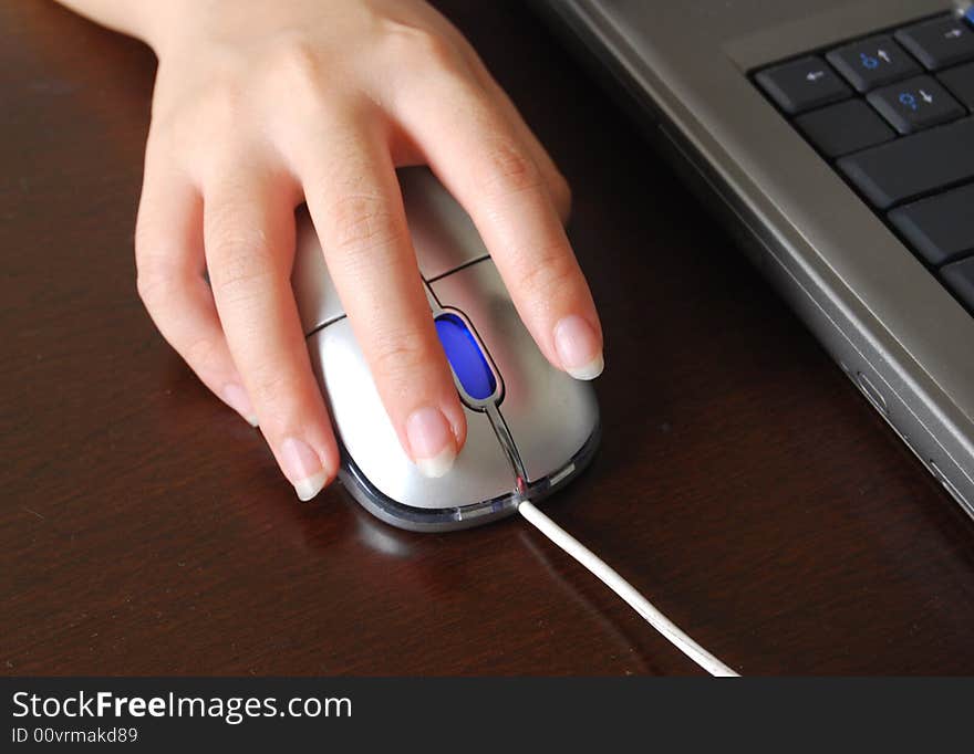 A lady hand using computer mouse. A lady hand using computer mouse