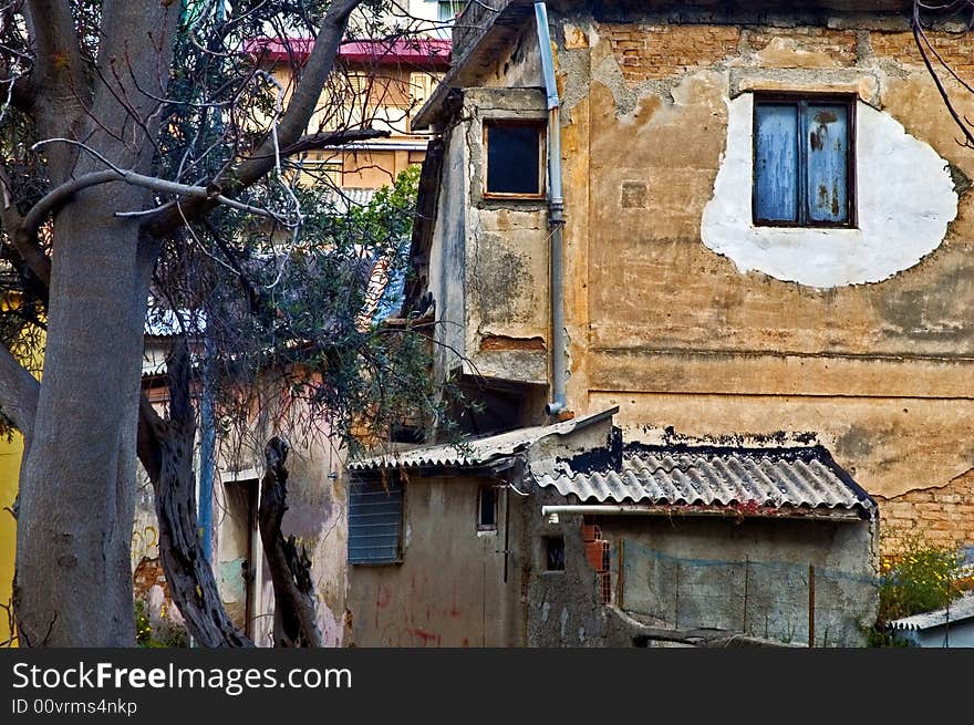 Decayed and spooky Italian house with barren tree. Decayed and spooky Italian house with barren tree