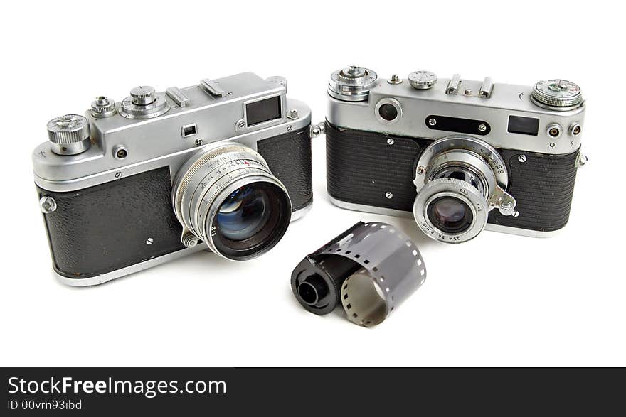 Vintage cameras with negativ film on white background.