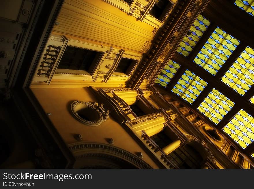 Neoclassical building interior with golden light and soft focus