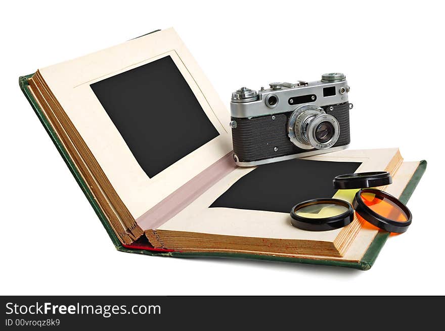 Old photo album with empty pictures and vintage camera with photofilters. Old photo album with empty pictures and vintage camera with photofilters