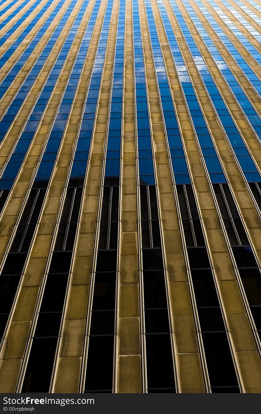 Skyscraper in NYC with beautiful cloud reflections and a symmetrical vanishing point. Skyscraper in NYC with beautiful cloud reflections and a symmetrical vanishing point.