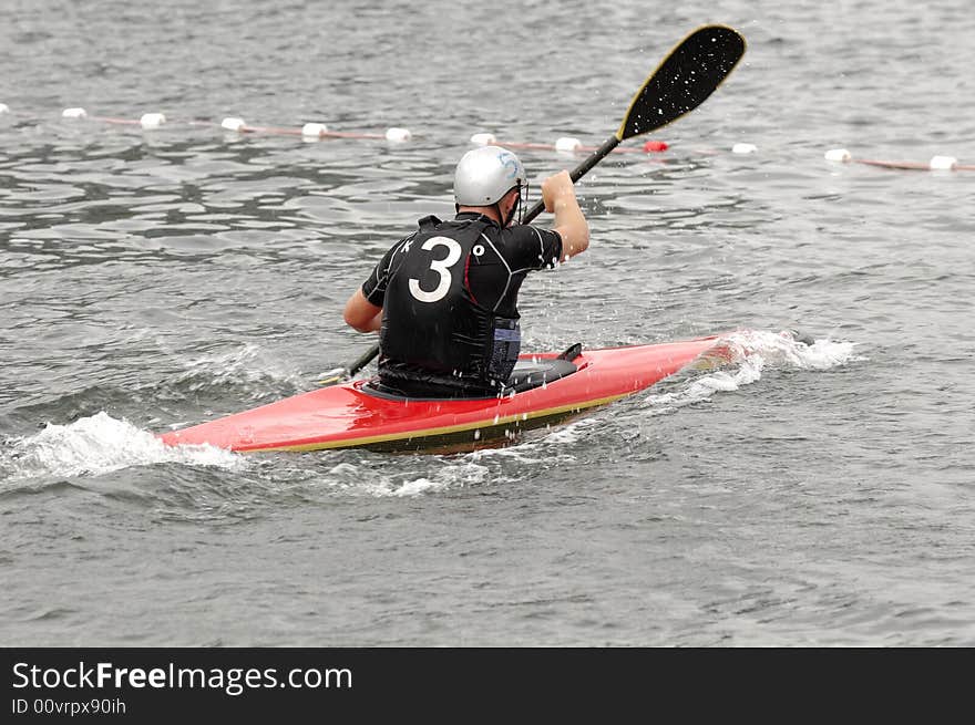 Man paddling in his kayak. Man paddling in his kayak