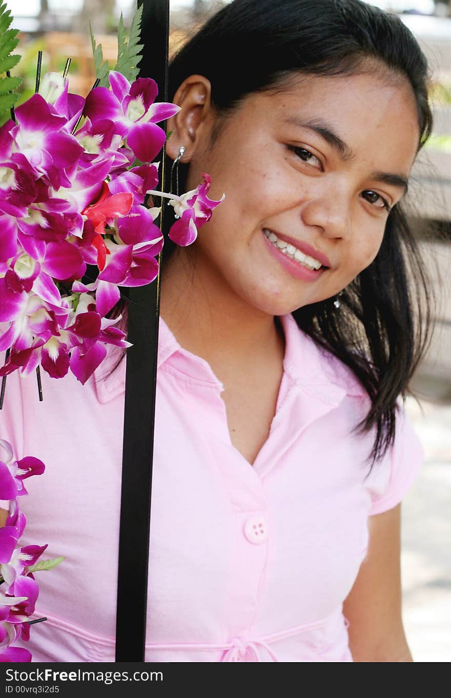 Portrait of a happy Thai woman with pink orchids. Portrait of a happy Thai woman with pink orchids.