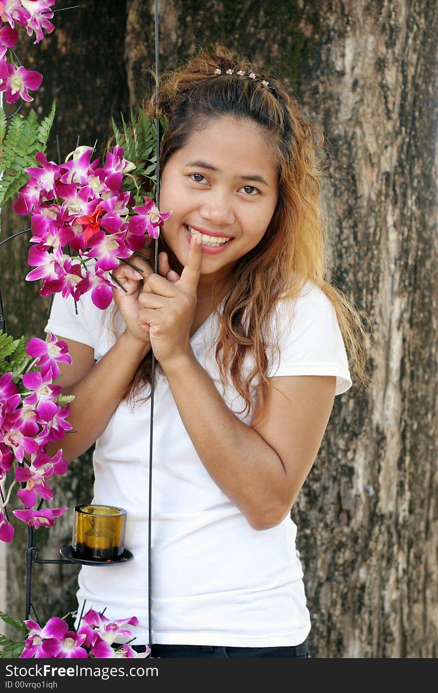 Portrait of a happy Thai woman with pink orchids. Portrait of a happy Thai woman with pink orchids.