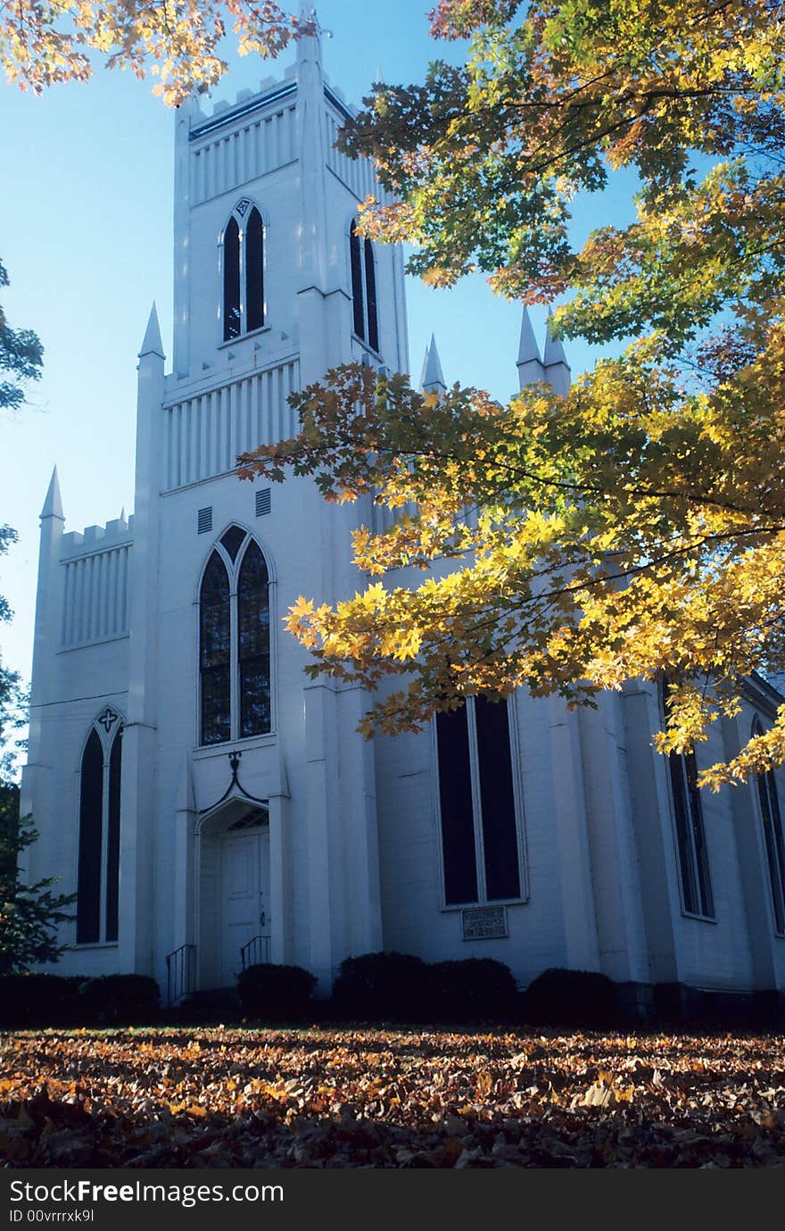 Towering church with autumn leaves scatrtered around. Towering church with autumn leaves scatrtered around