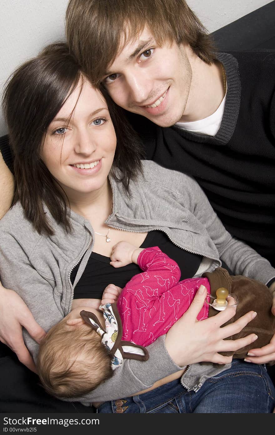 Happy young parents with their baby girl