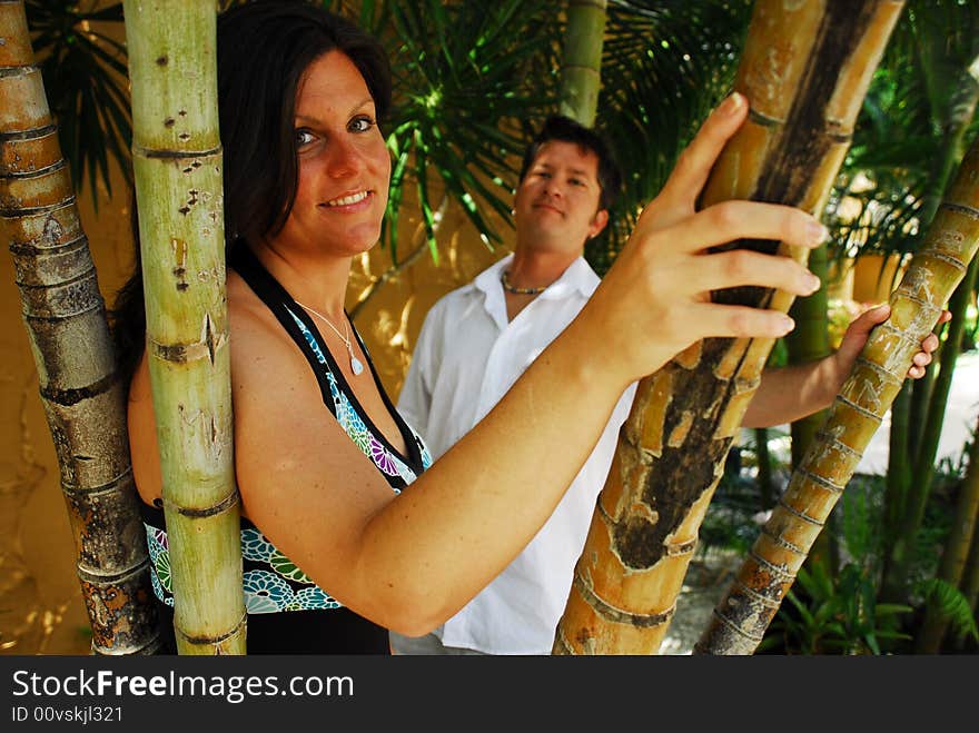 Romantic couple posing in a bamboo garden. Romantic couple posing in a bamboo garden.