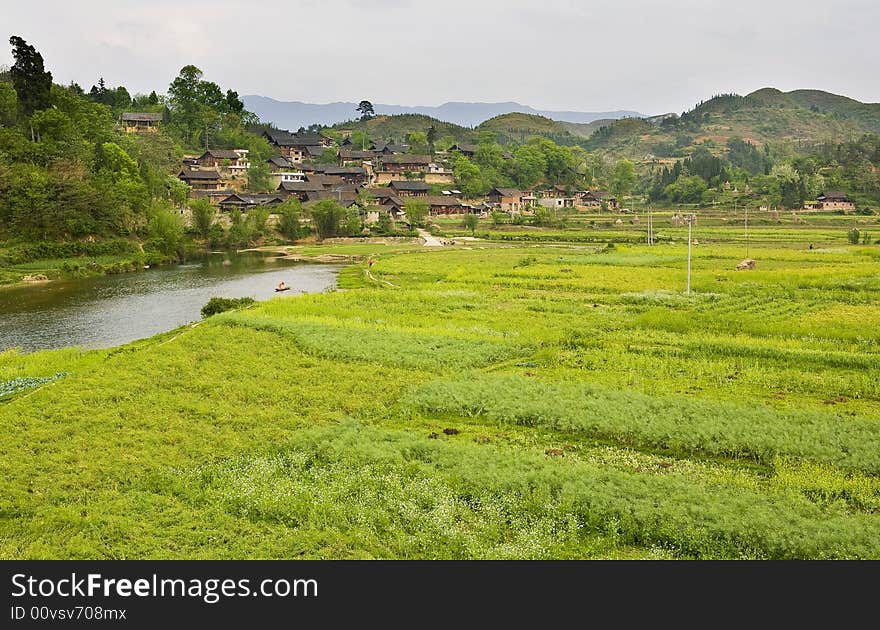 The village is in spring with the cole fields & thr river. The village is in spring with the cole fields & thr river