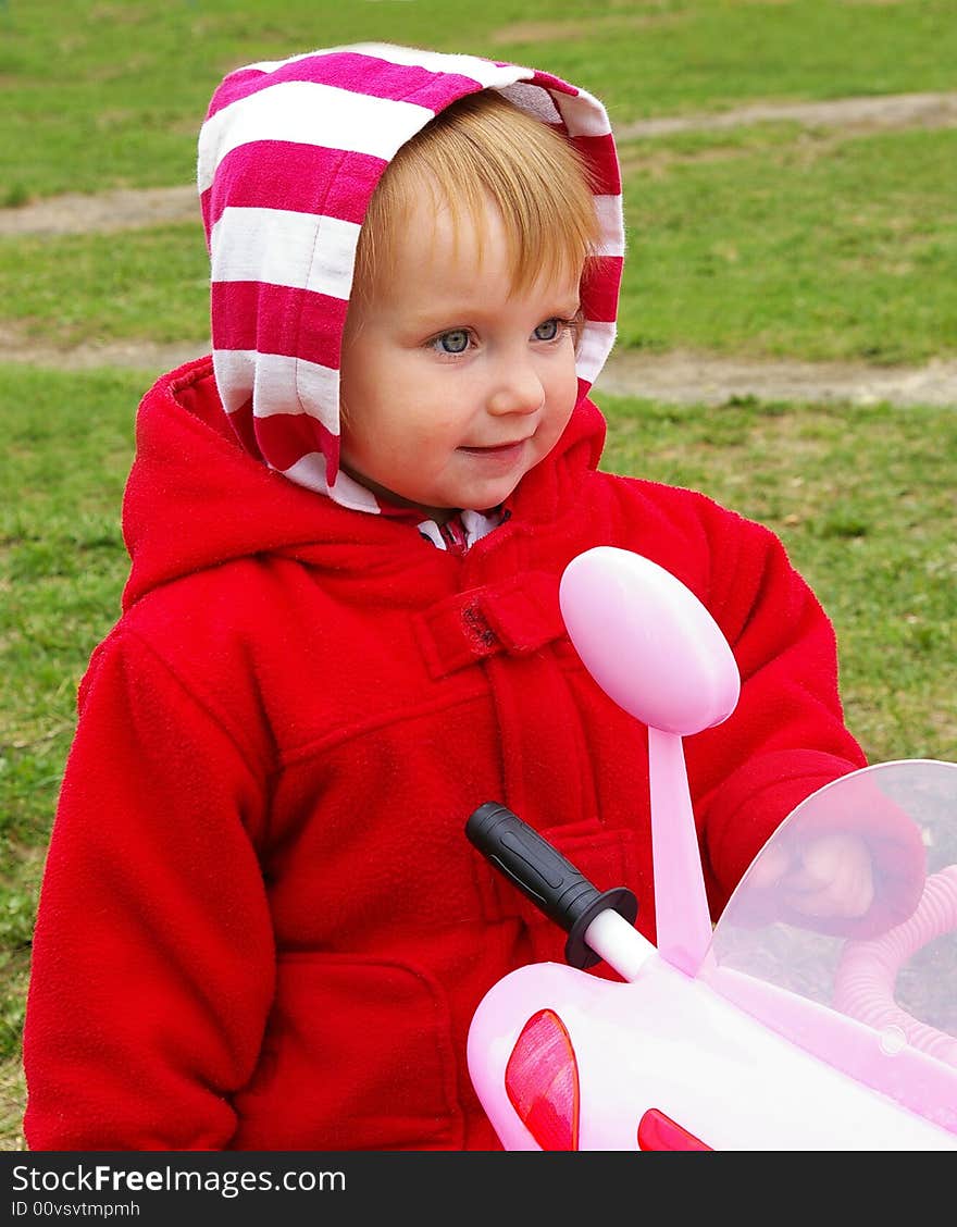 Little nice girl and her tricycle