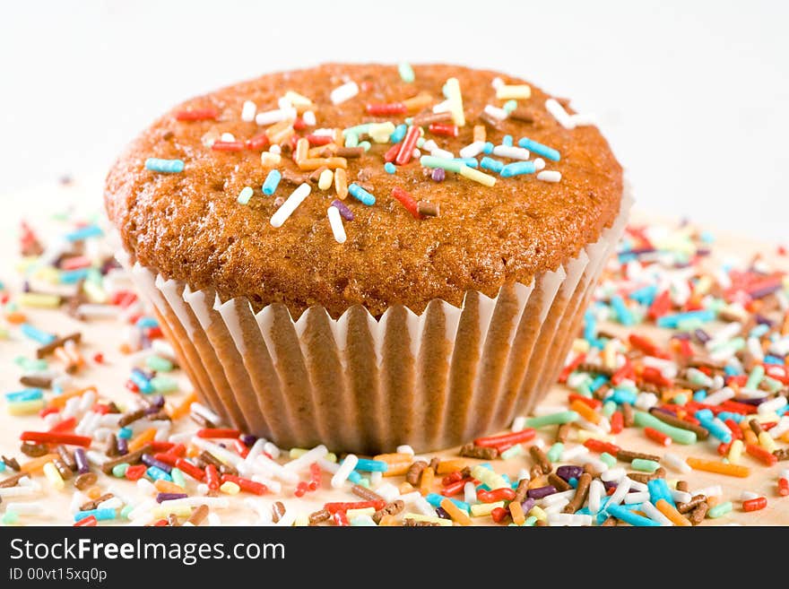 Tasty muffin with colorful sprinkles