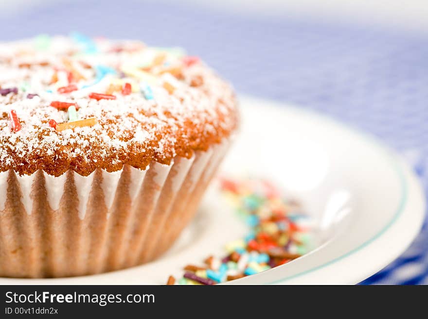 Tasty muffin with colorful sprinkles