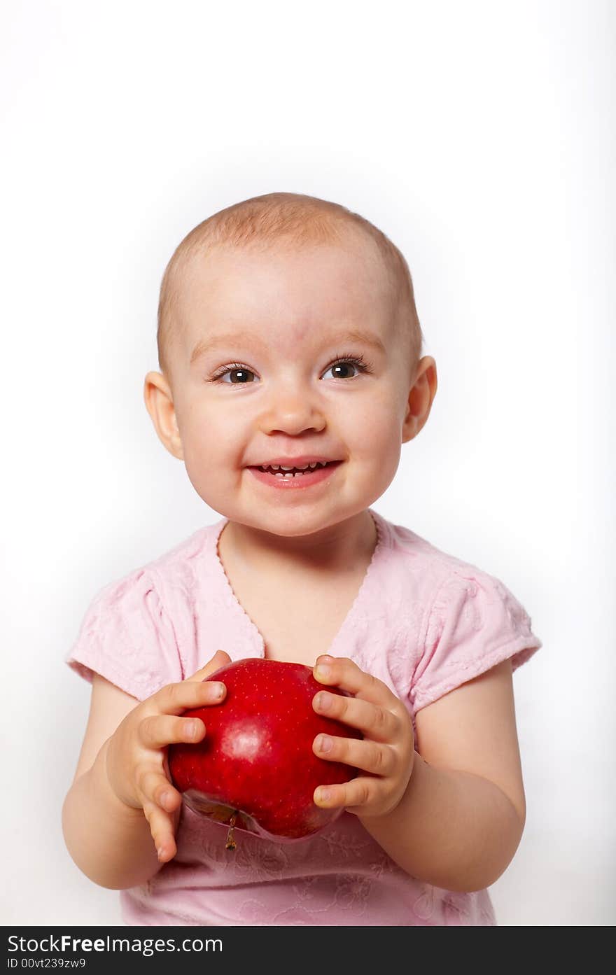 Portrait of happy baby with apple