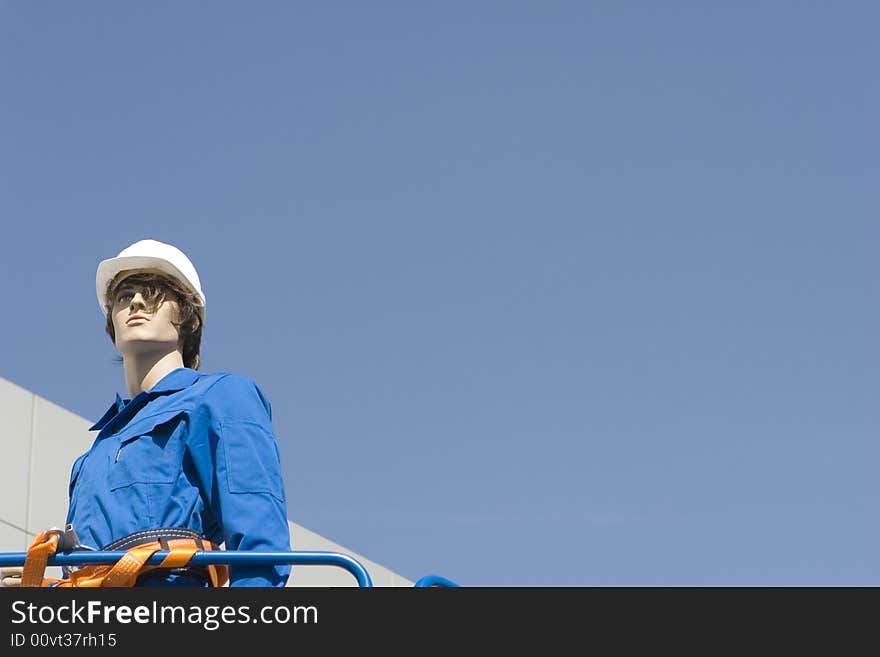 Dummy in building clothes on a background of the sky