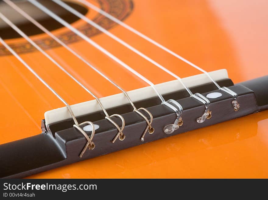 Acoustic guitar bridge and strings close up