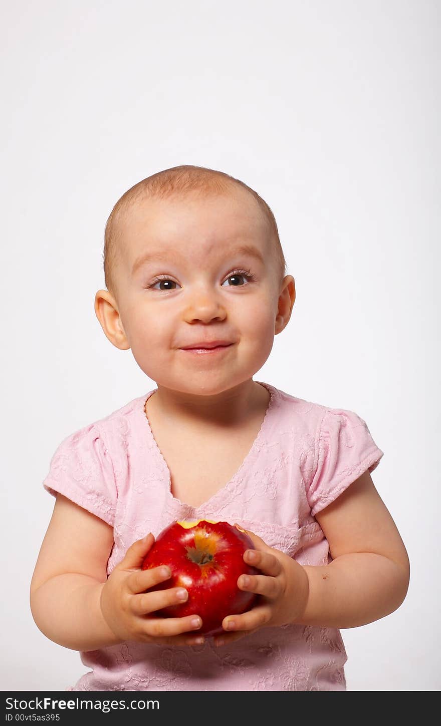 Portrait of happy baby with apple