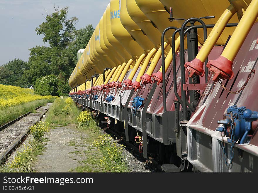 Rail transport with yellow silos in the port area photographed