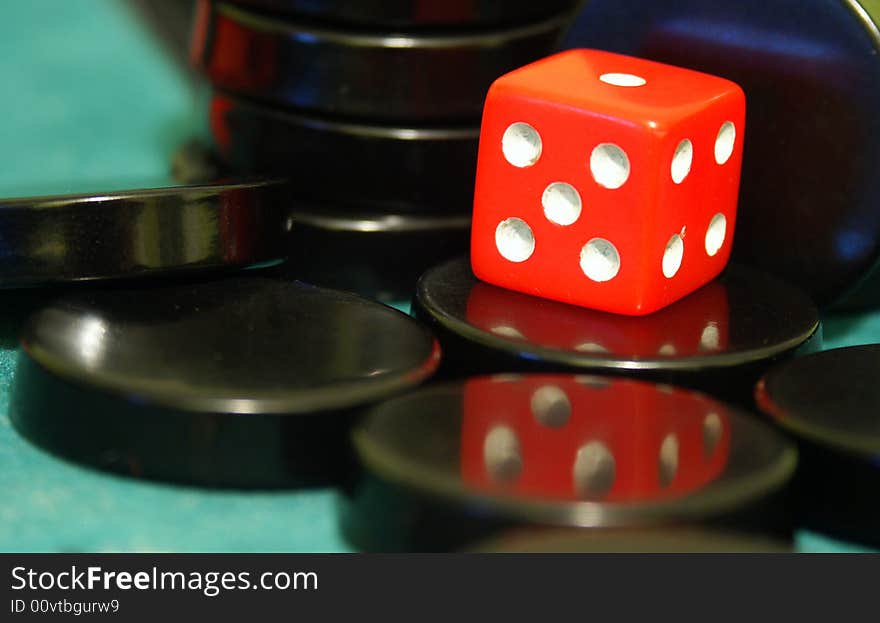 Red cube used to play backgammon. Red cube used to play backgammon