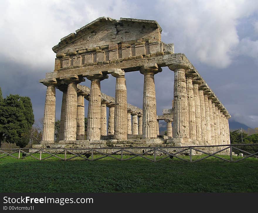 Dark clouds hanging over one of the ancient temples of Paestum, Italy