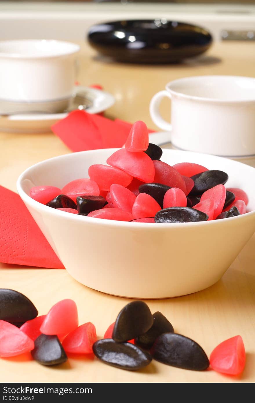 Candy with coffee cups in the background. Candy with coffee cups in the background