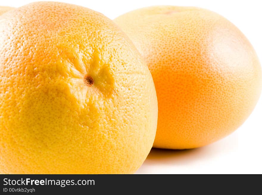 Fresh juicy grapefruit. Close up on a white background. Fresh juicy grapefruit. Close up on a white background.