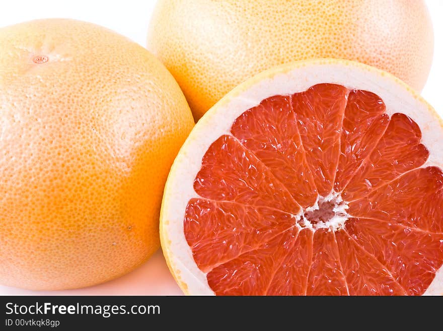 Fresh juicy grapefruit. Close up on a white background. Fresh juicy grapefruit. Close up on a white background.