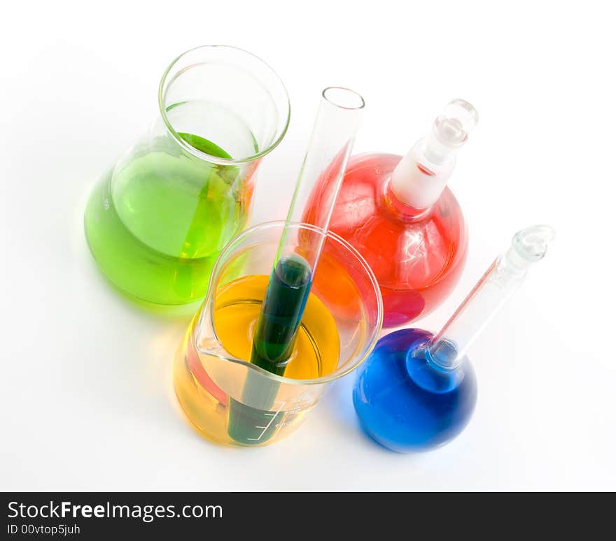 Various colorful flasks over white background