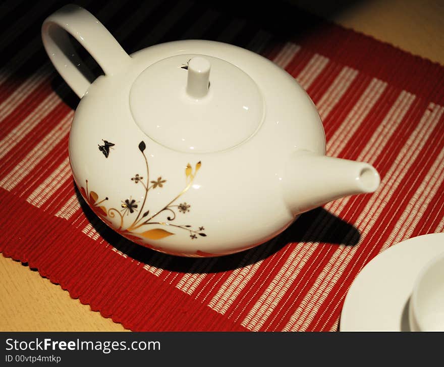 White teapot with beutiful flower pattern