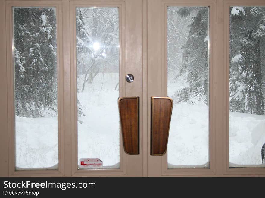 The outside storm is visible from inside the church through glass doors. The outside storm is visible from inside the church through glass doors.