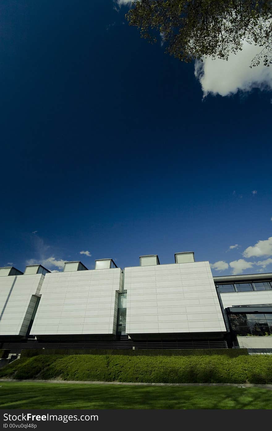 Wide view of a modern building, copy space on the deep blue sky area. Wide view of a modern building, copy space on the deep blue sky area.