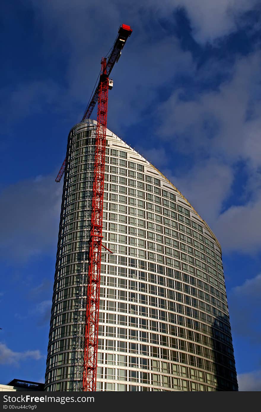 Crane next to silver modern apartment