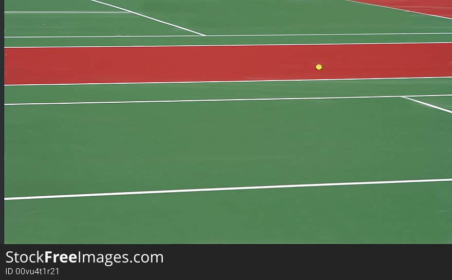 View of two tennis courts with a yellow ball. View of two tennis courts with a yellow ball